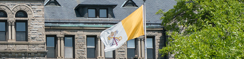 Papal flag in front of McMahon Hall