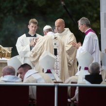 Pope Francis assisted by a deacon and servers