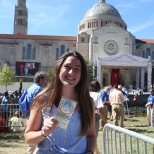 A student with her ticket and the Basilica in the background.