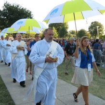 Deacons, accompanied by student volunteers, process to distribute communion.