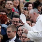 Alumnus Ajani Gibson (far left) exchanges zuchettos with Pope Francis during a 2013 audience in Rome.