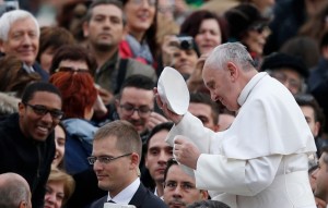 Alumnus Ajani Gibson (far left) exchanges zuchettos with Pope Francis during a 2013 audience in Rome. 