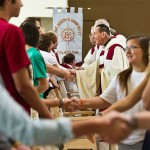 Parishioners share the sign of peace.