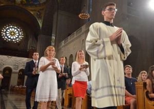 Members of the University community, including Jeanne Garvey, bring up the gifts during the Mass of the Holy Spirit. 