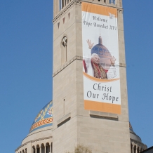 A banner on the bell tower of the Basilica of the National Shrine of the Immaculate Conception welcomes Pope Benedict XVI in 2008.