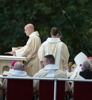 The deacon prepares the altar for the Liturgy of the Eucharist