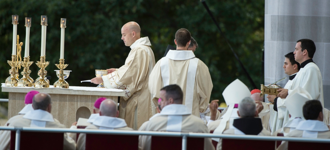 The deacon prepares the altar for the Liturgy of the Eucharist