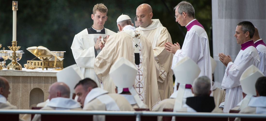 Pope Francis assisted by a deacon and servers