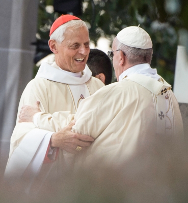 Cardinal Donald Wuerl embracing Pope Francis