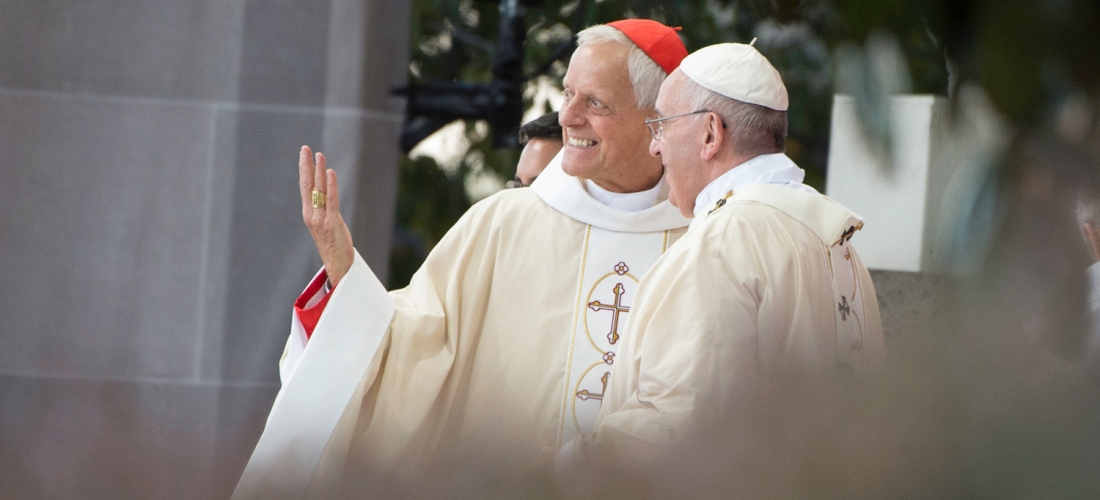 Cardinal Wuerl gestures to the crowd as he speaks to Pope Francis