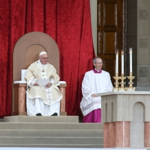 Pope Francis seated in the chair designed by CUA students.