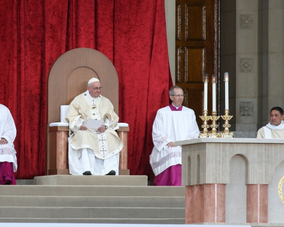 Pope Francis seated in the chair designed by CUA students.