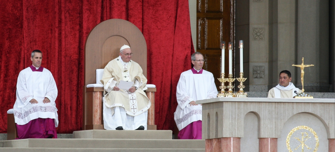 Pope Francis seated in the chair designed by CUA students.