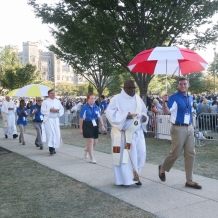 Deacons distributing Communion were escorted by volunteers carrying umbrellas.