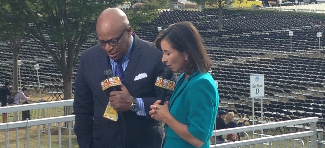 Reporters test their equipment on the riser before the Mass.