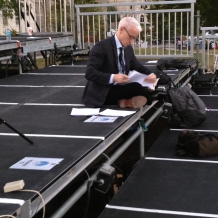 CNN’s Anderson Cooper prepares for his news show on the media riser.