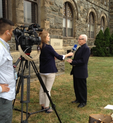 A media interview in front of Caldwell Hall.