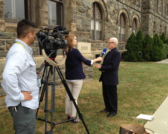 A media interview in front of Caldwell Hall.
