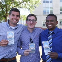 Students display their tickets for the Mass.