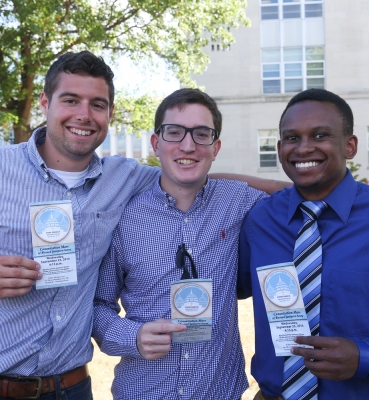 Students display their tickets for the Mass.