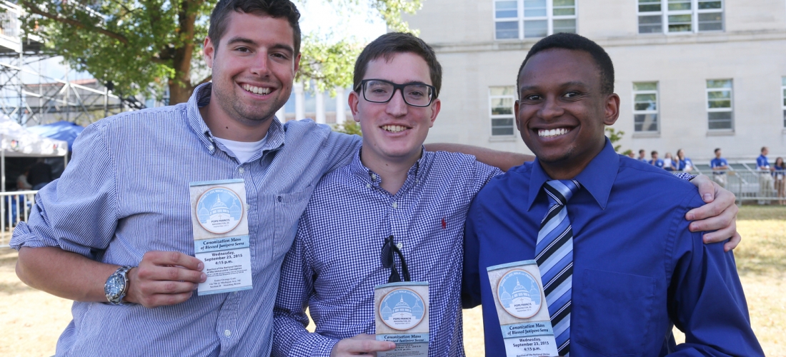 Students display their tickets for the Mass.