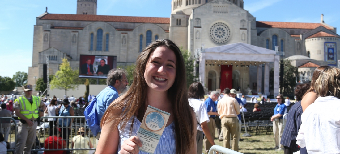 A student with her ticket and the Basilica in the background.