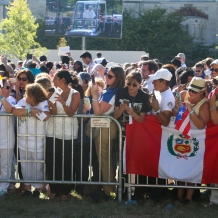 People in the crowd with smartphones poised to photograph the Pope