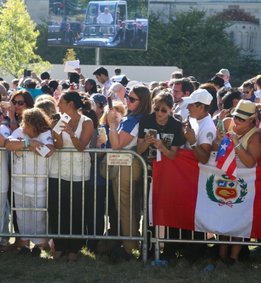 People in the crowd with smartphones poised to photograph the Pope