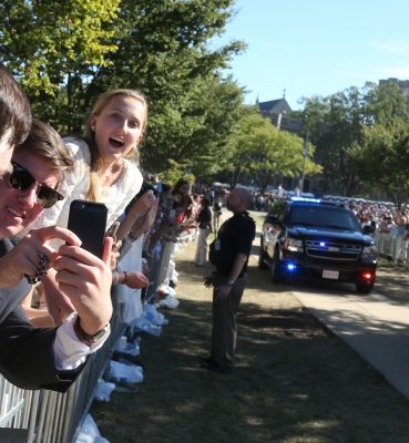 Leaning out over the fence on the University Mall to get a better view of Pope Francis.