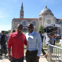 Early arrivals stop for a photo before the Mass.