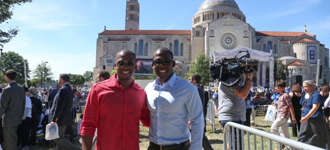 Early arrivals stop for a photo before the Mass.