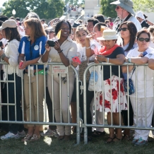 Waiting at the fence line for the popemobile to pass by.