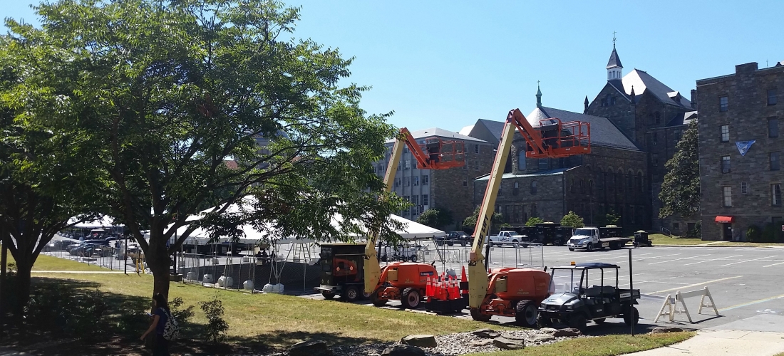 Preparation for the Pope’s visit begin in the parking lot behind McMahon Hall.